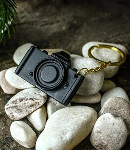 3D Printed dslr camera keychain for photographers, on white stone number 3