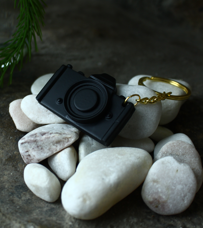 3D Printed dslr camera keychain for photographers, on white stone number 2