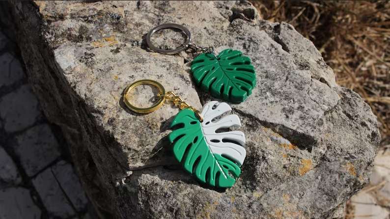 Monstera Leaf keychains on raw stone 